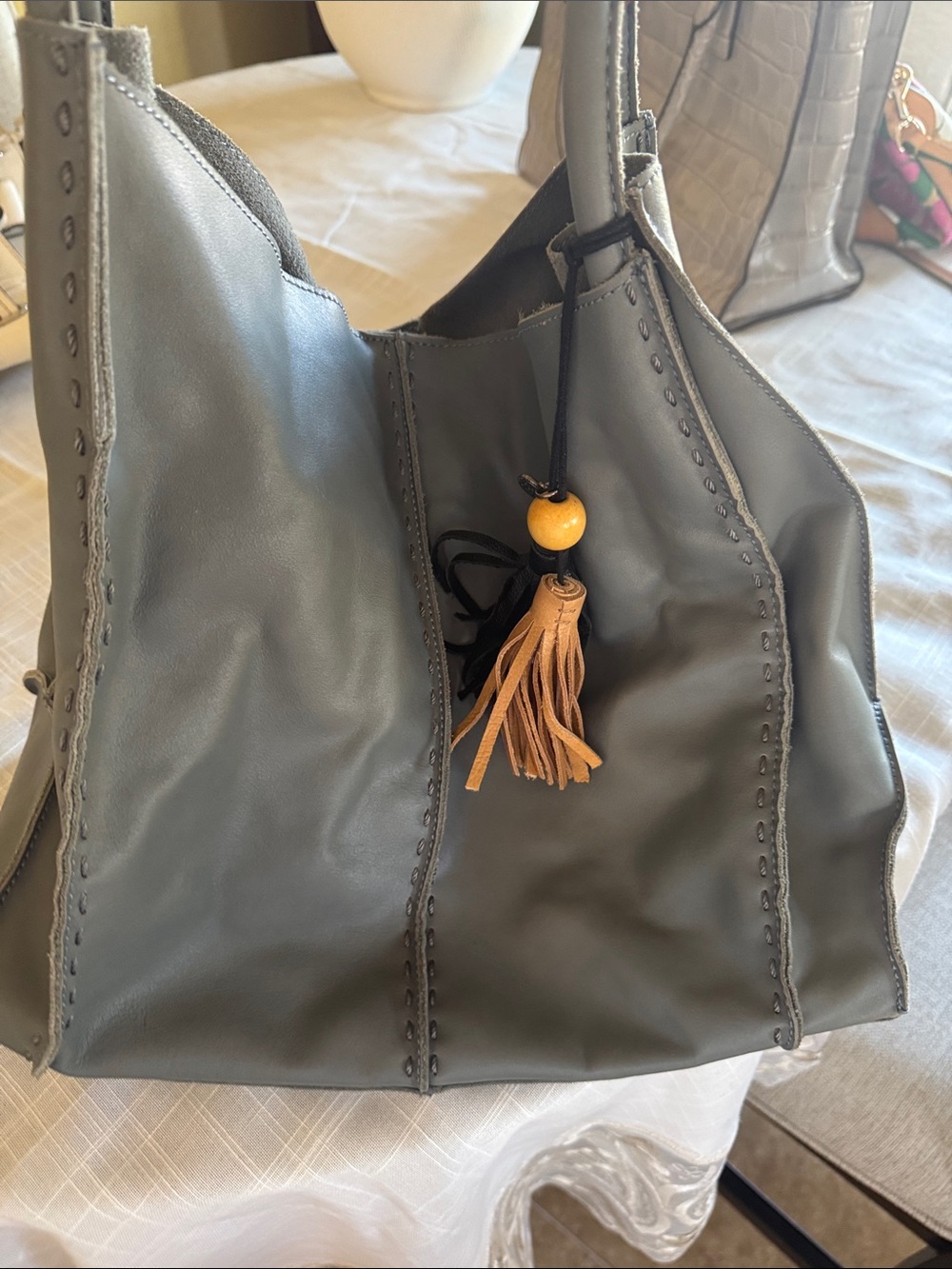The Sak Gray Leather Shoulder Bag with Tan Tassel